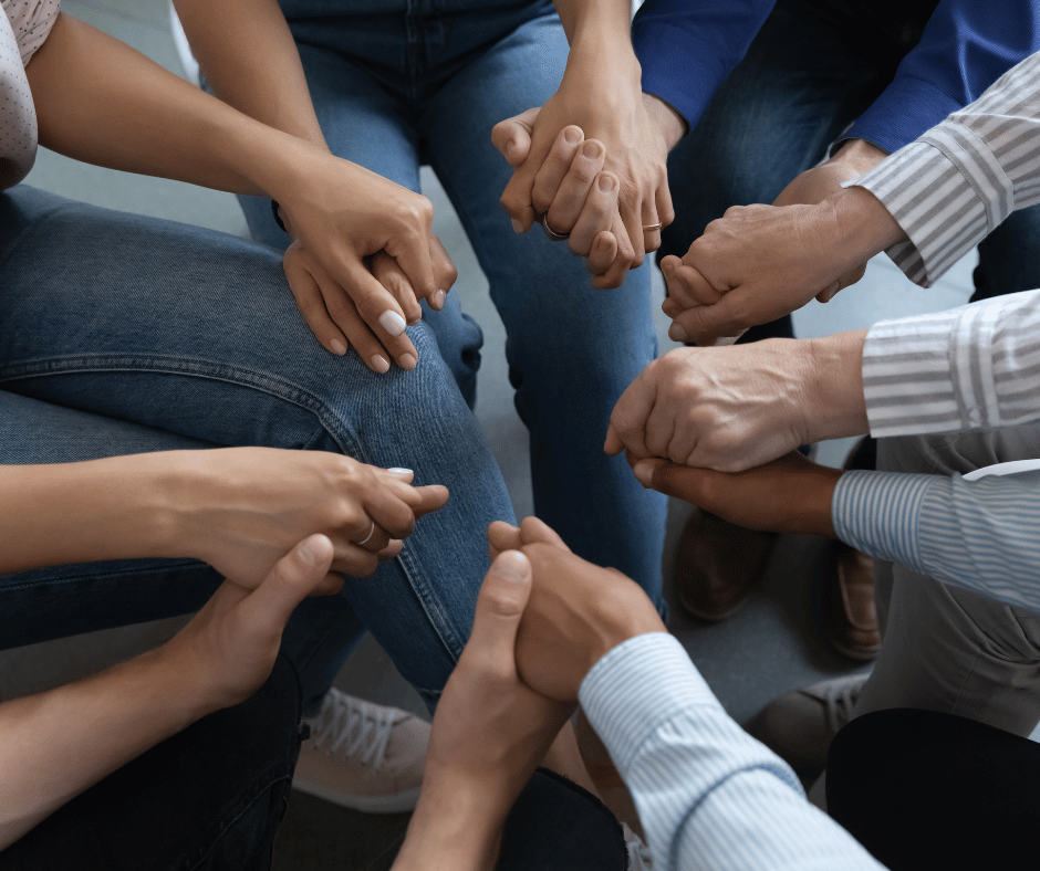 Transformed Life Coaching image of a group holding hands